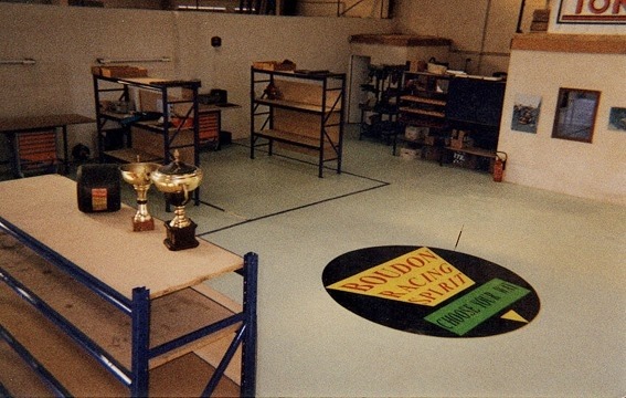 Boudon Racing Spirit workshop interior with trophies and floor logo