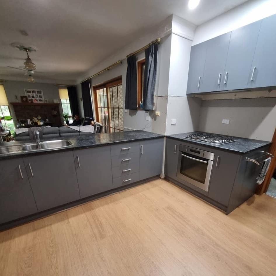 Modern grey kitchen cabinets with dark countertop