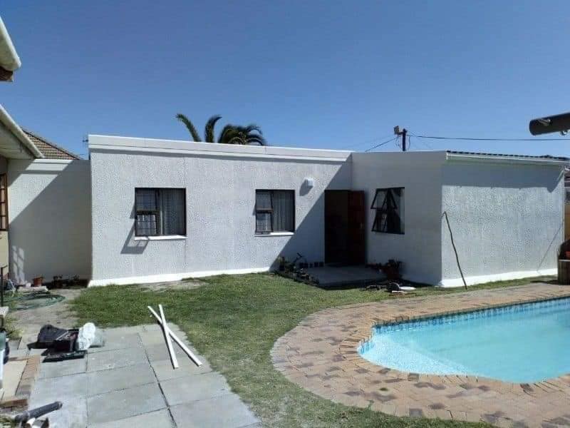White house renovation with pool