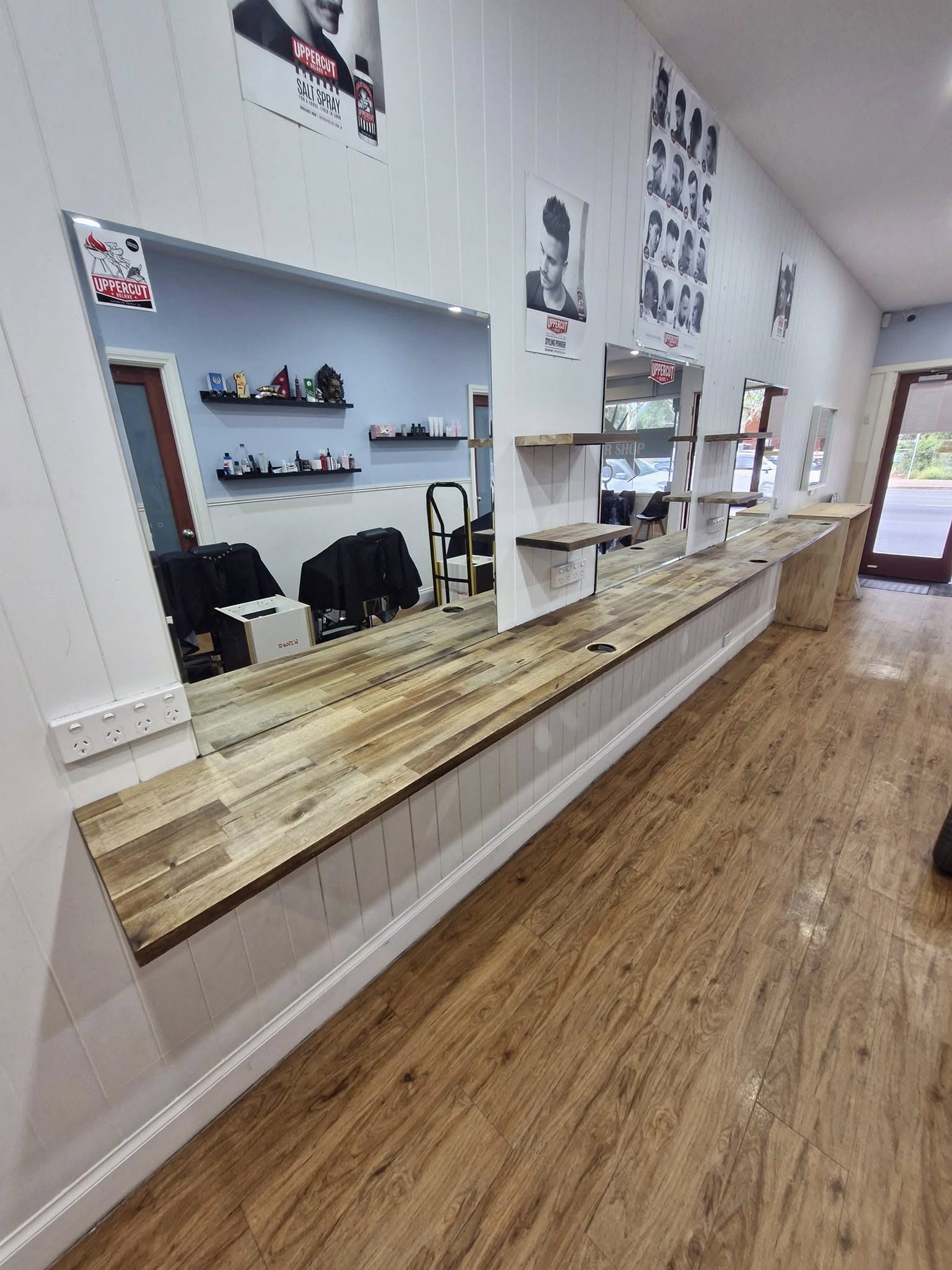 Commercial timber countertop installation with custom shelving