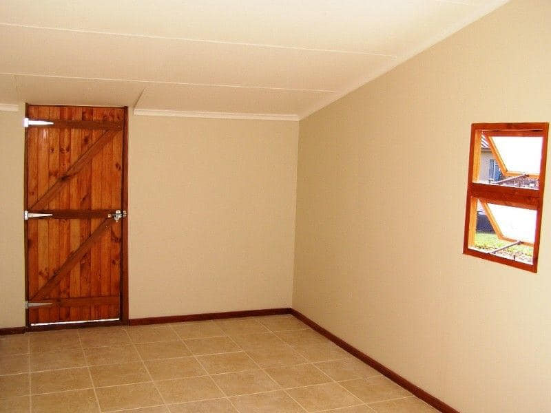 Interior room with wooden door and tiled floor