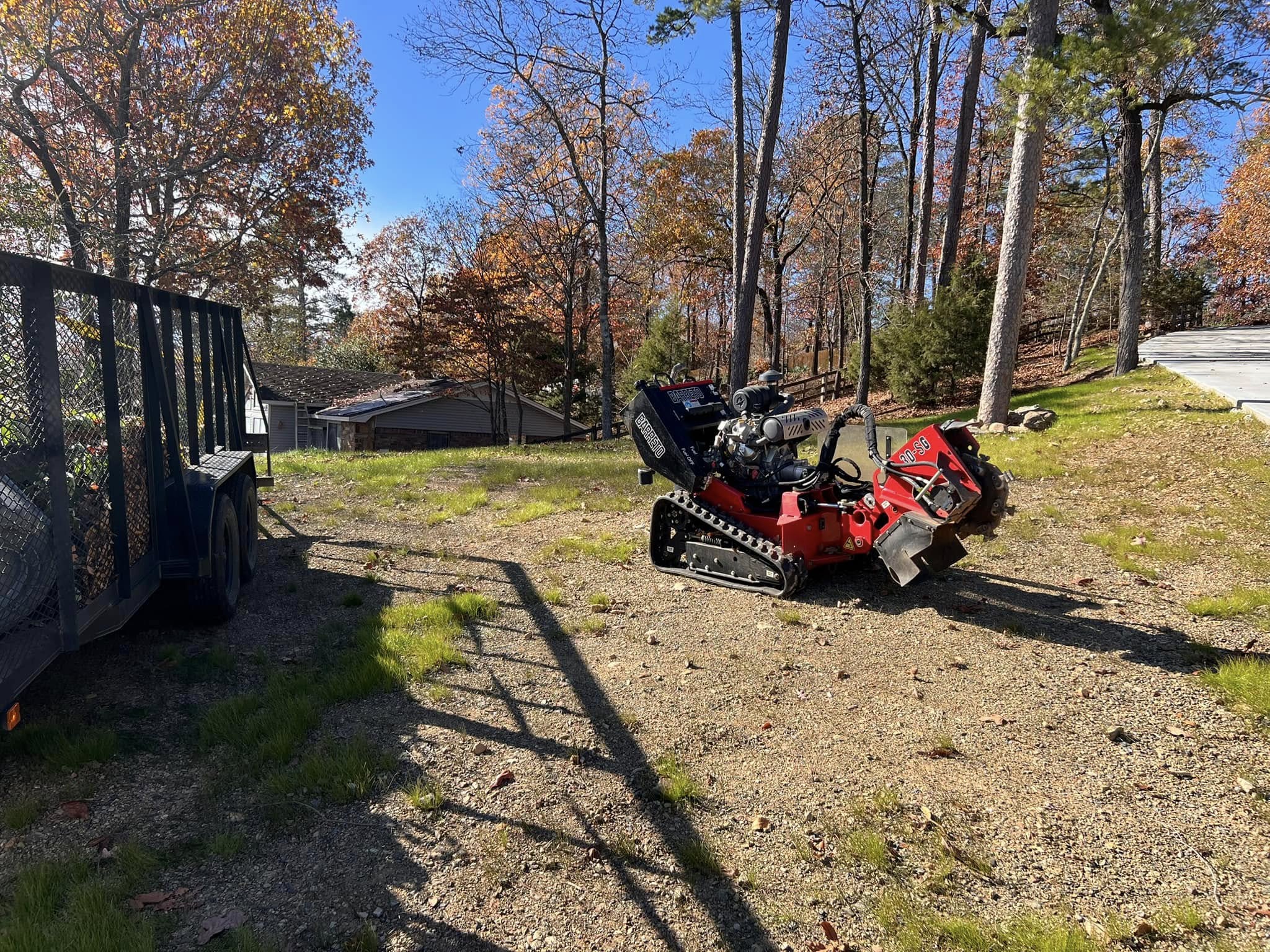 Equipment setup with Barreto grinder and trailer in fall wooded setting