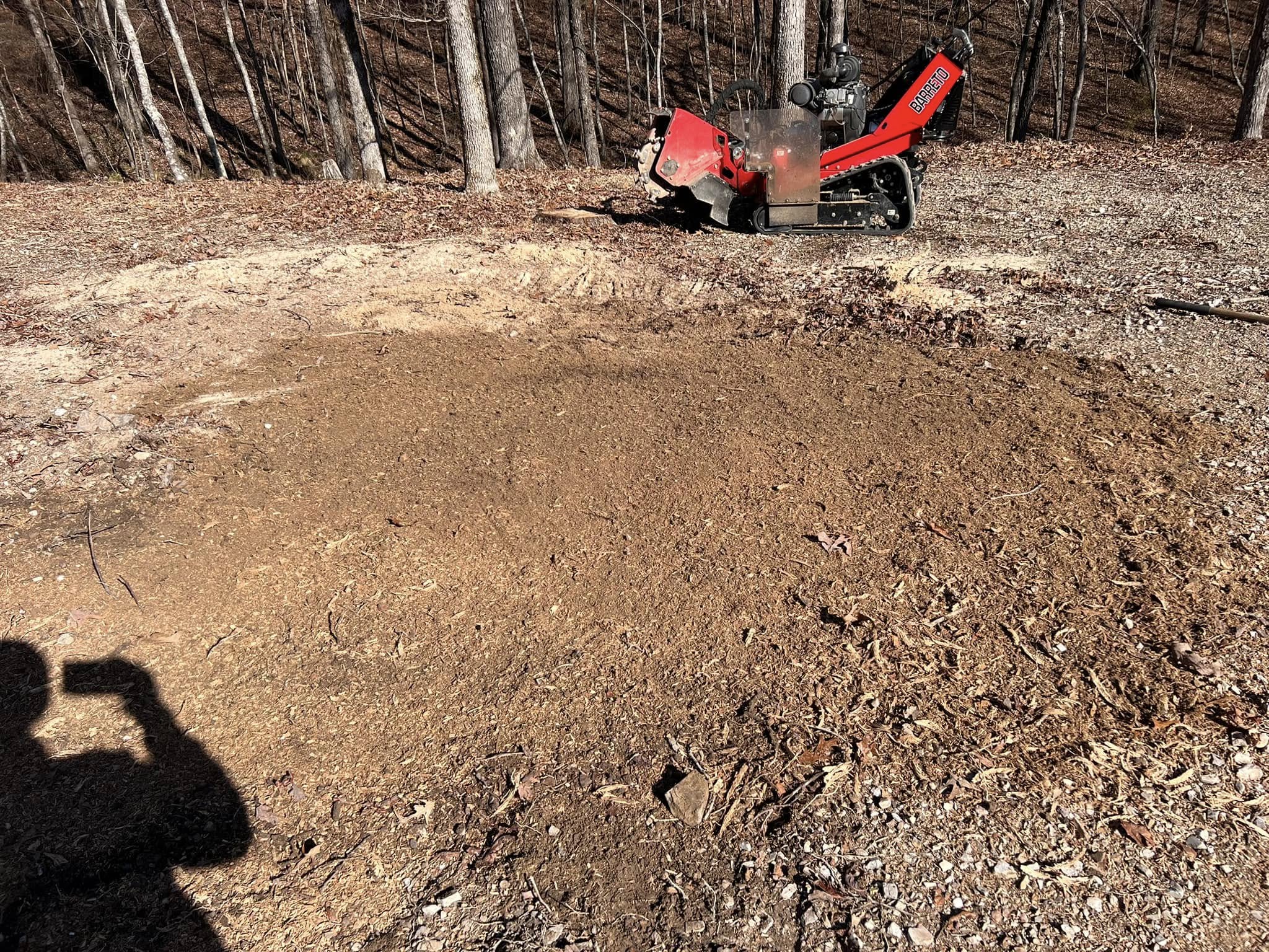 Completed large lot clearing showing mulched area on wooded hillside