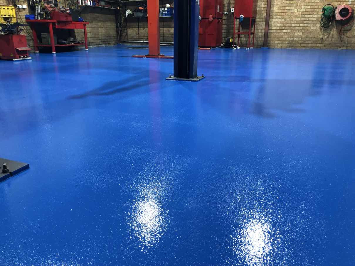 Clean uniform solid-colour blue plain epoxy floor in a Sydney workshop