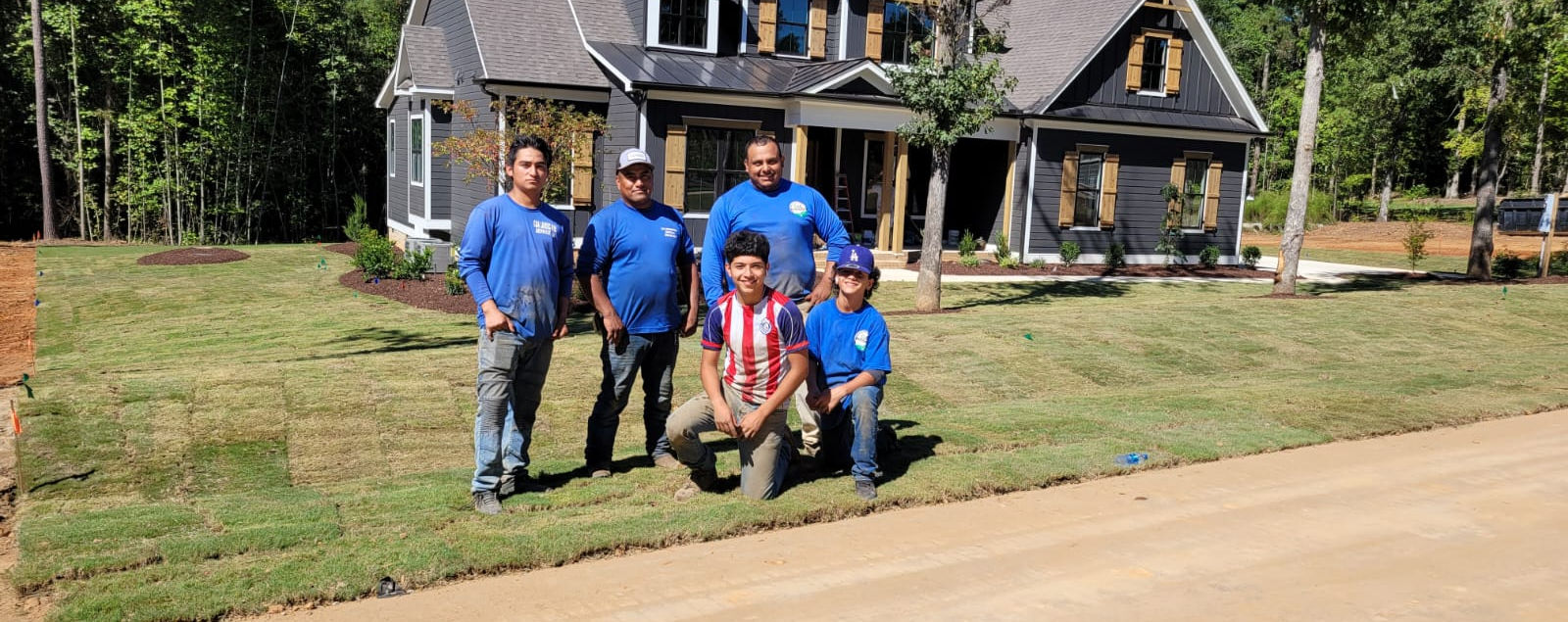 The C&A Landscaping crew at a completed lawn project