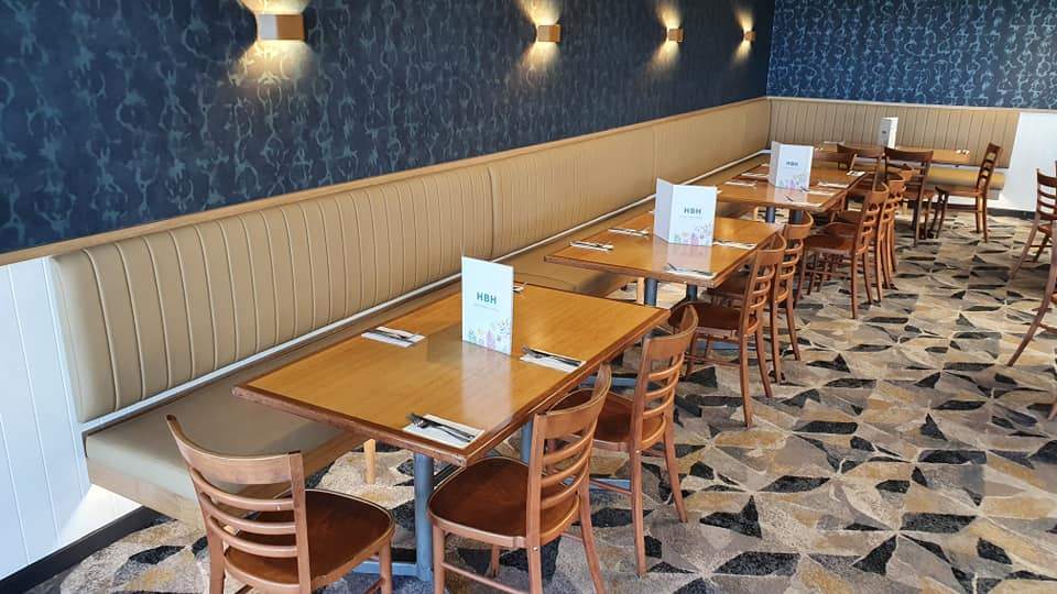 Commercial restaurant booth seating with timber tables and leather upholstery
