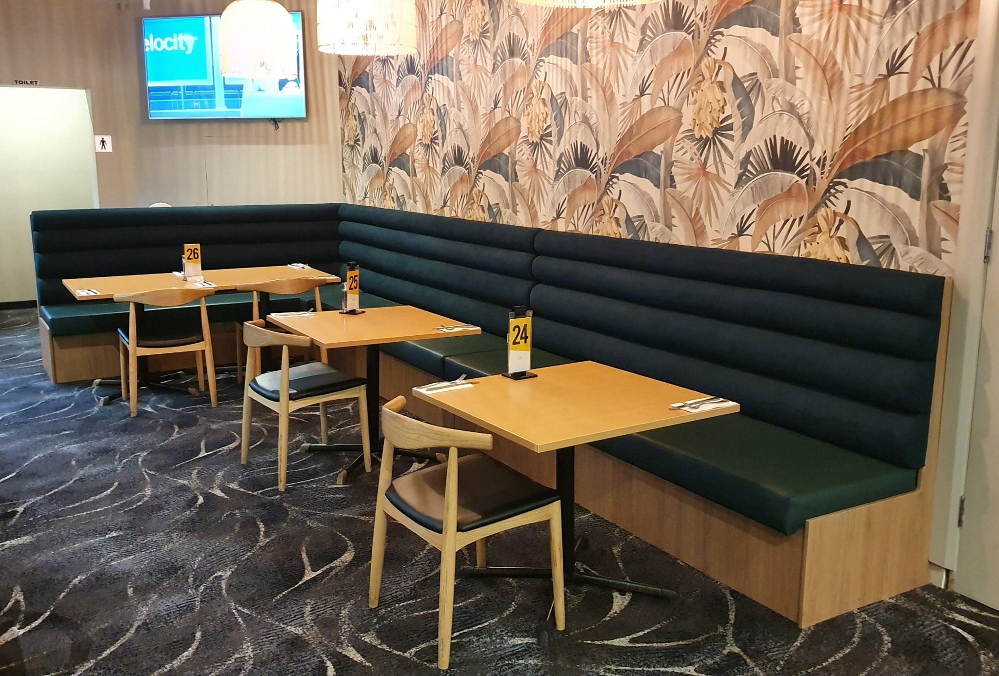 Commercial bathroom with custom timber slat floating vanity and arched backlit mirrors