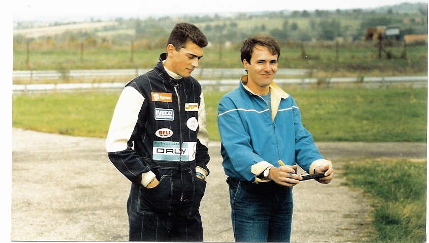 Young Christian Boudon taking notes while coaching a driver trackside