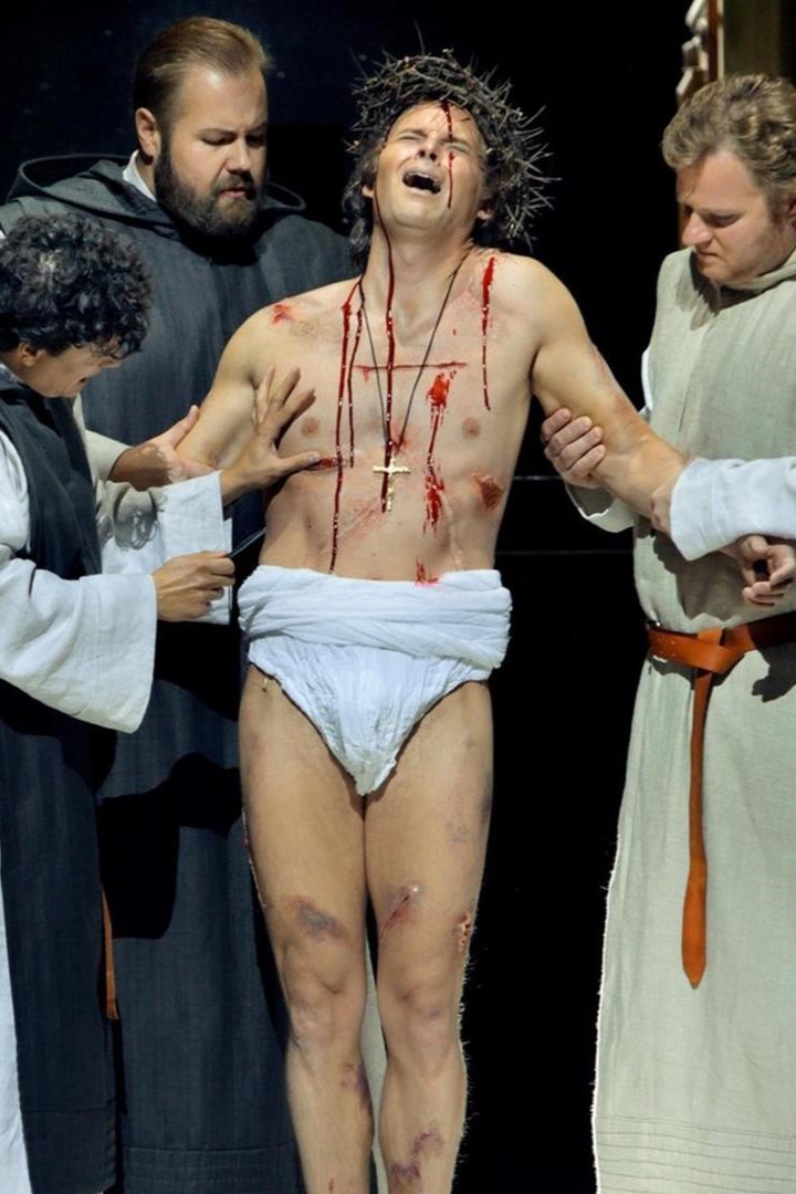 Theatrical performance of a Christ figure with a crown of thorns