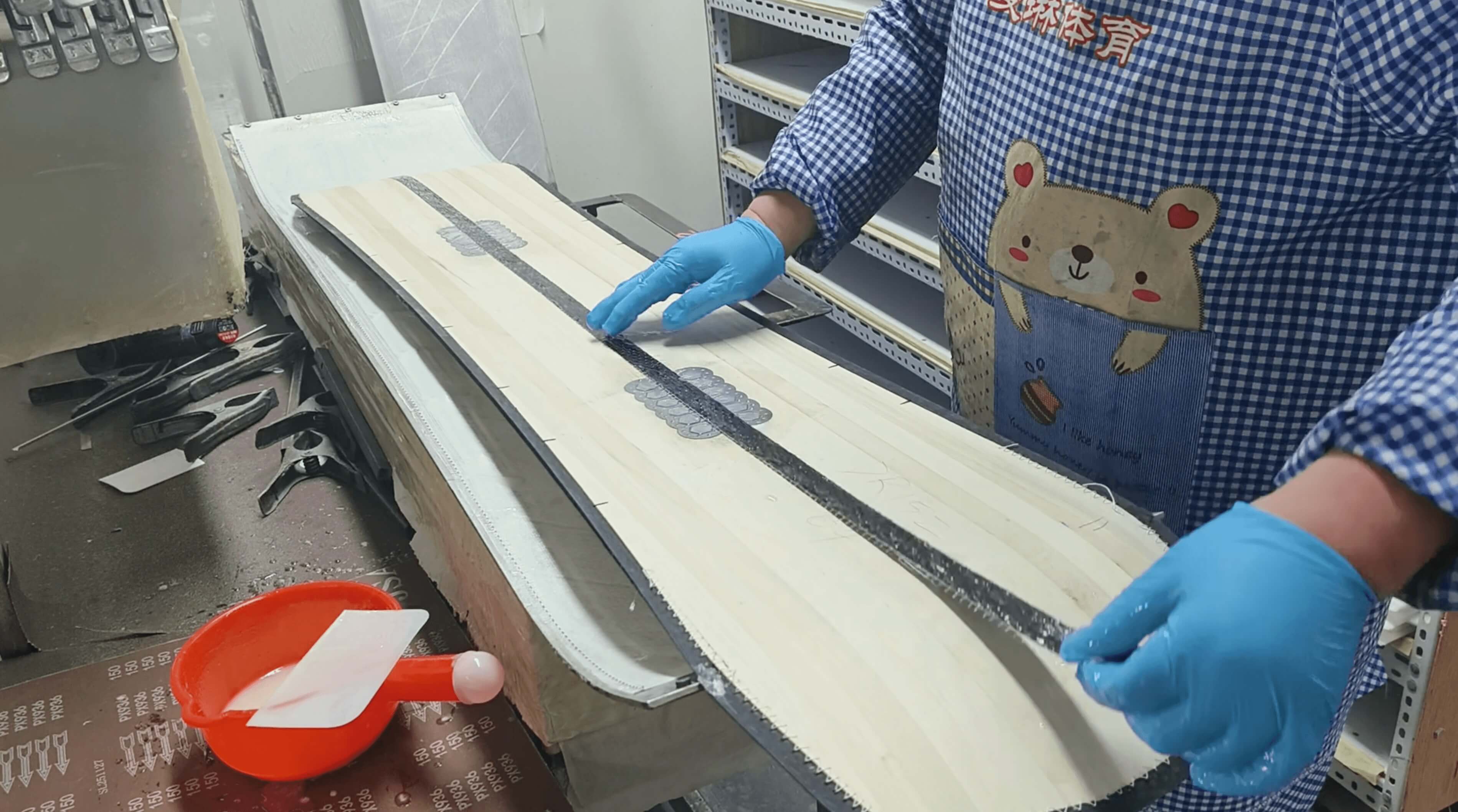 Carbon fiber reinforcement strips positioned on the wood core