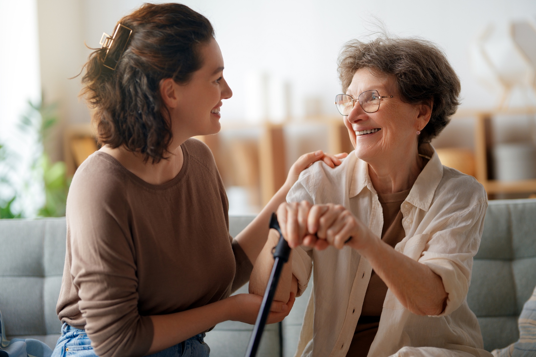 Caregiver and elderly woman having a warm conversation
