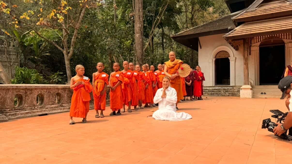 Prayer pose with young monks in orange robes