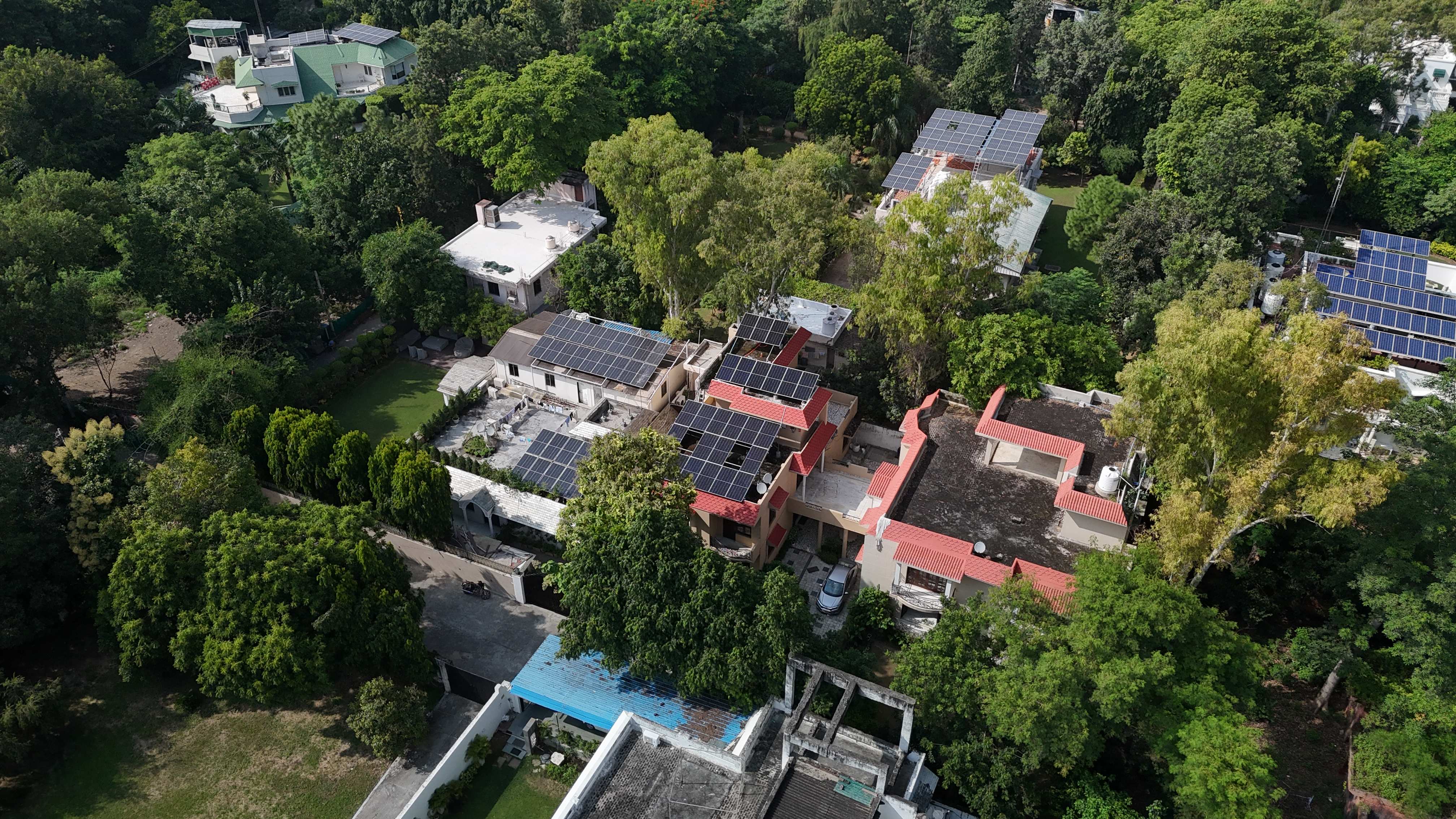 Aerial view of a residential neighbourhood with multiple rooftop solar installations