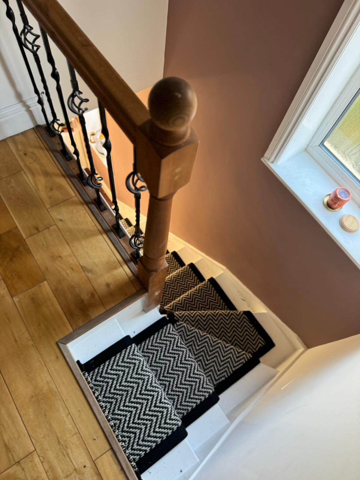 Staircase with chevron pattern carpet runner
