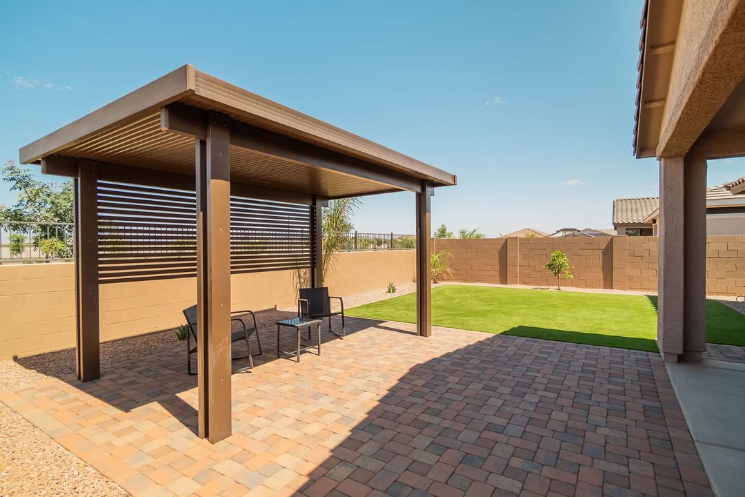 Bronze solid patio cover with louvered wall over paver patio
