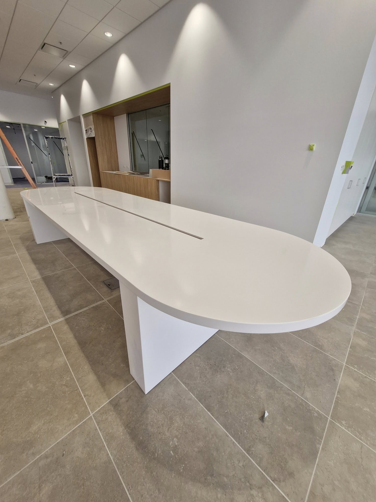 Modern white oval conference table in commercial space