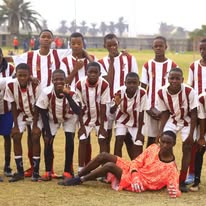 Liberator FC team in white and red striped jerseys