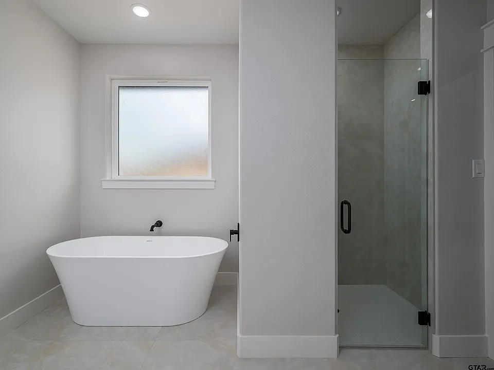 Bathroom with freestanding soaker tub and glass shower