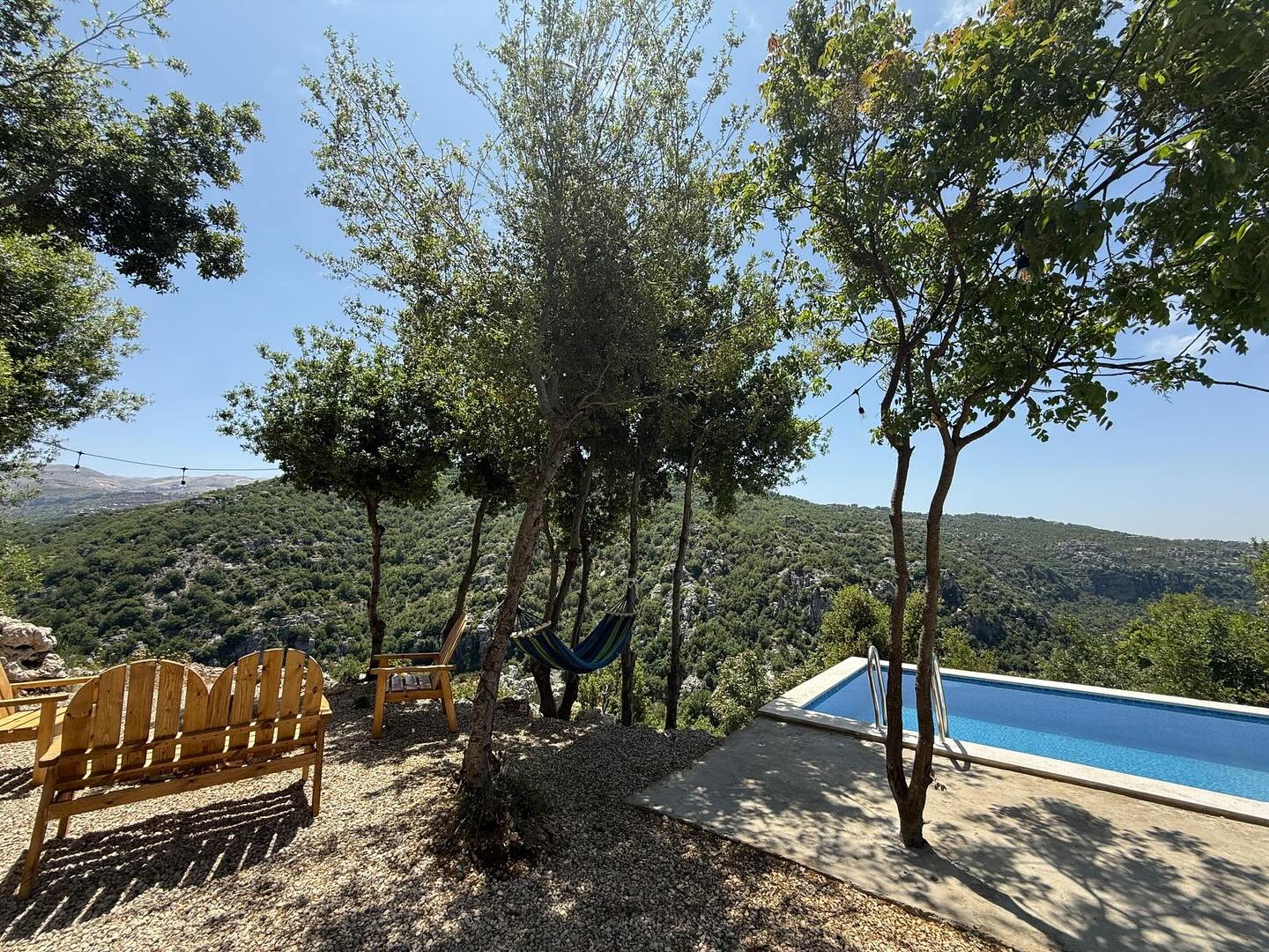 Private garden with hammock and pool overlooking mountains