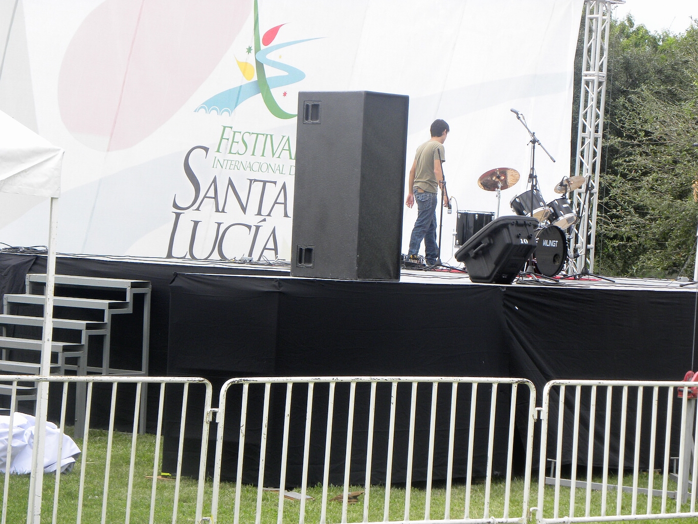 Tarima negra con panel decorativo Festival Internacional Santa Lucía, escenario para presentaciones musicales con carpa blanca y estructura de truss