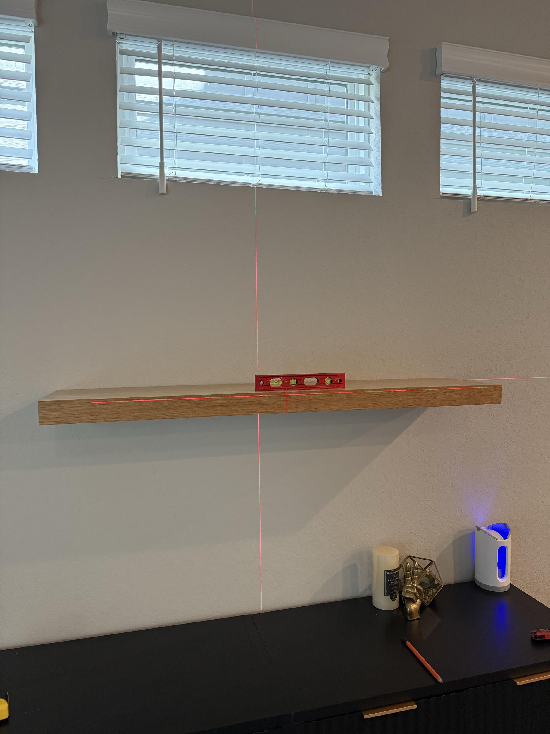 Floating shelf installation with laser level