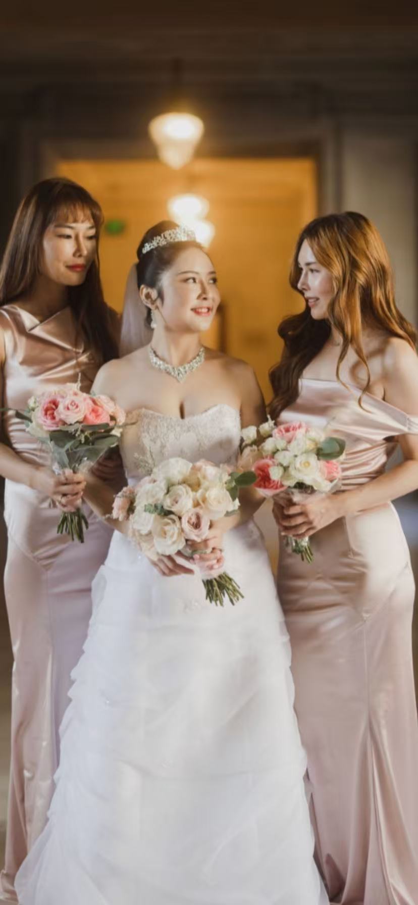 Bride with bridesmaids in pink satin dresses