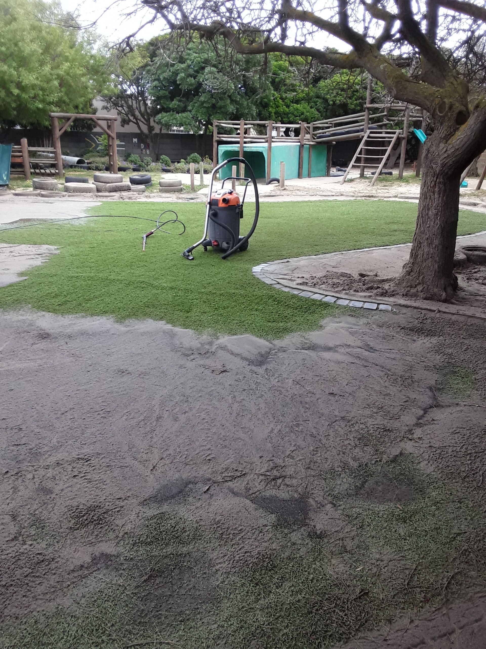 Sandy debris-covered turf before cleaning
