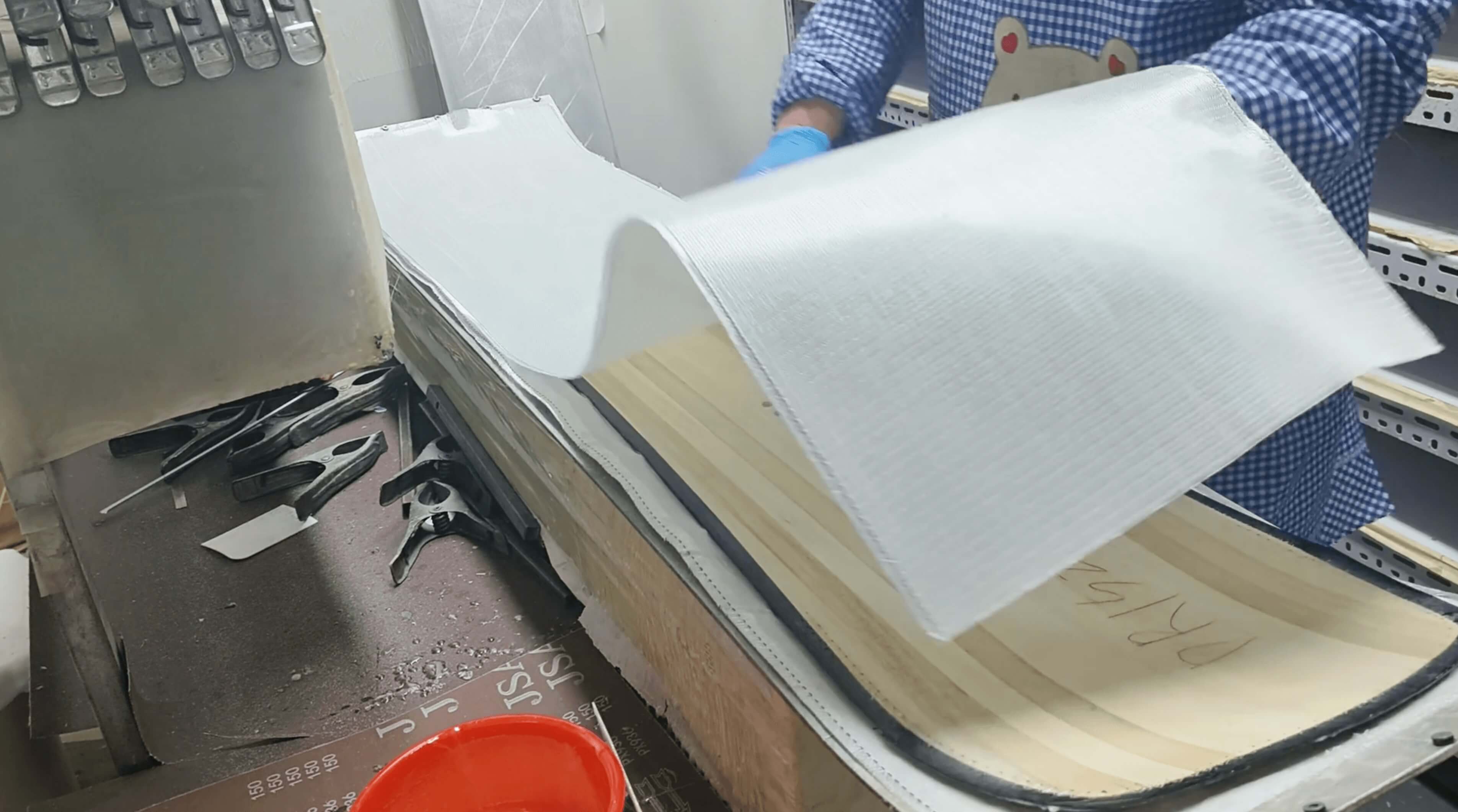 Upper fiberglass sheet being draped over the full board stack