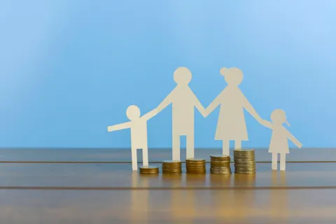 Family with stacked coins representing financial support