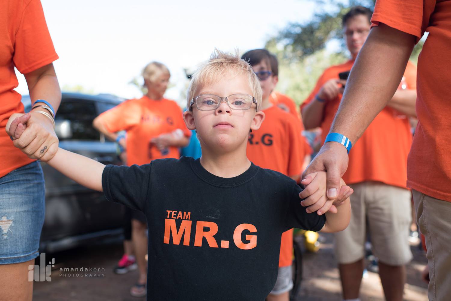 Young boy with Team Mr. G shirt at community event