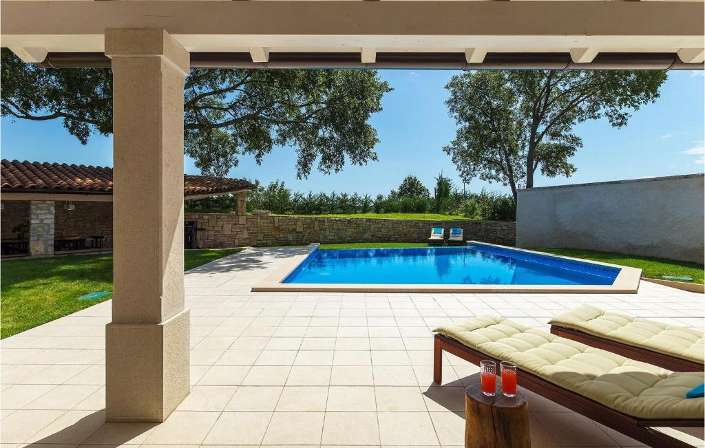 Pool view from covered terrace with cocktails