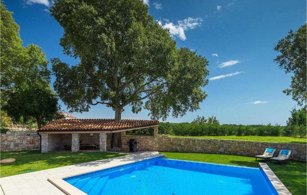 Pool with stone gazebo and landscaped garden