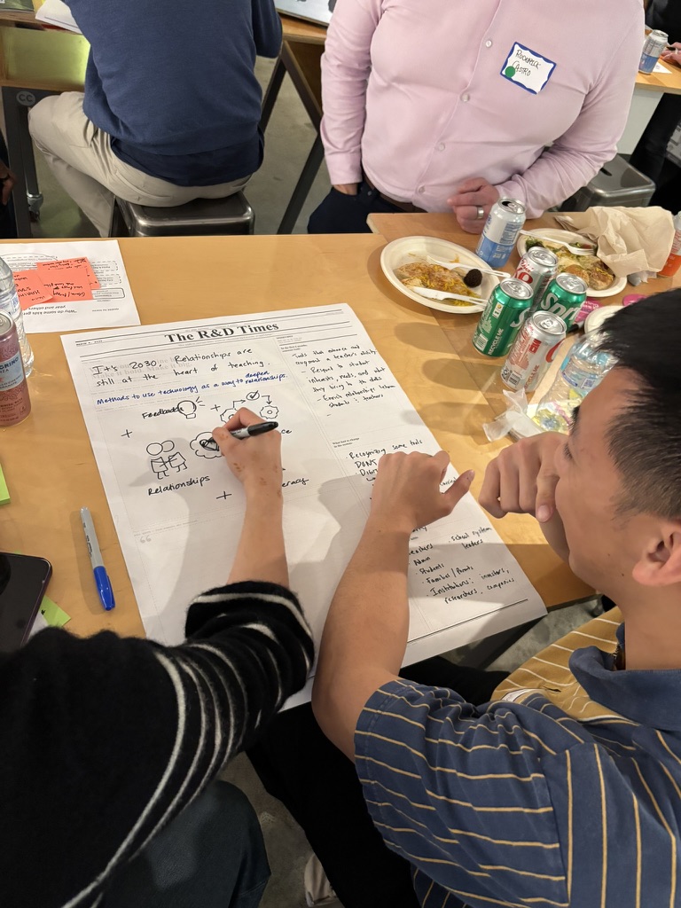Participant filling out The R&D Times template while eating with table mates
