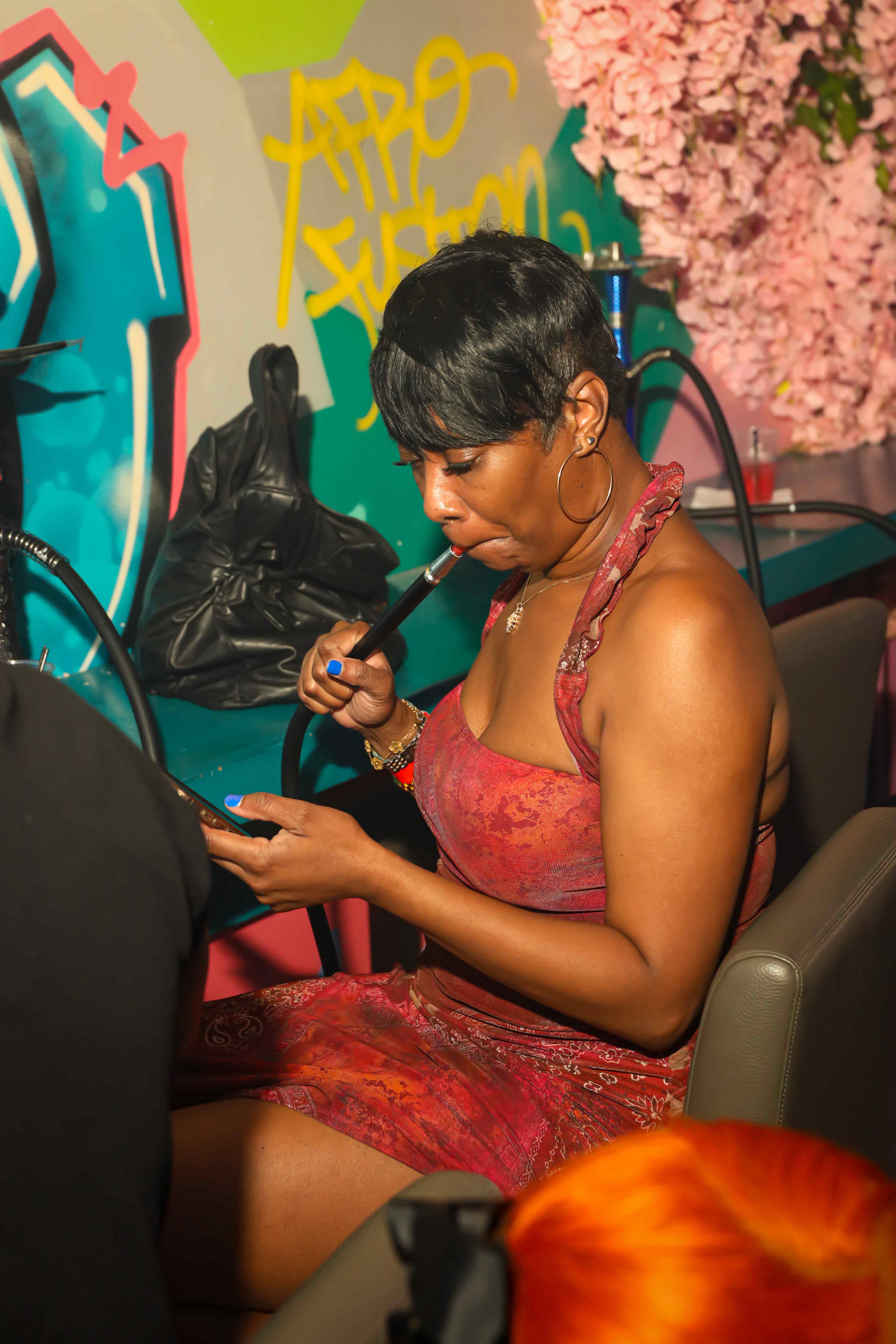 Guest enjoying hookah at graffiti wall