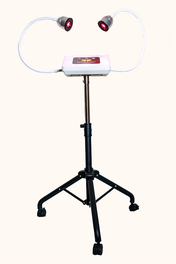 Full MemoraCare unit mounted on a black wheeled tripod stand, with its two curved white light arms and control panel