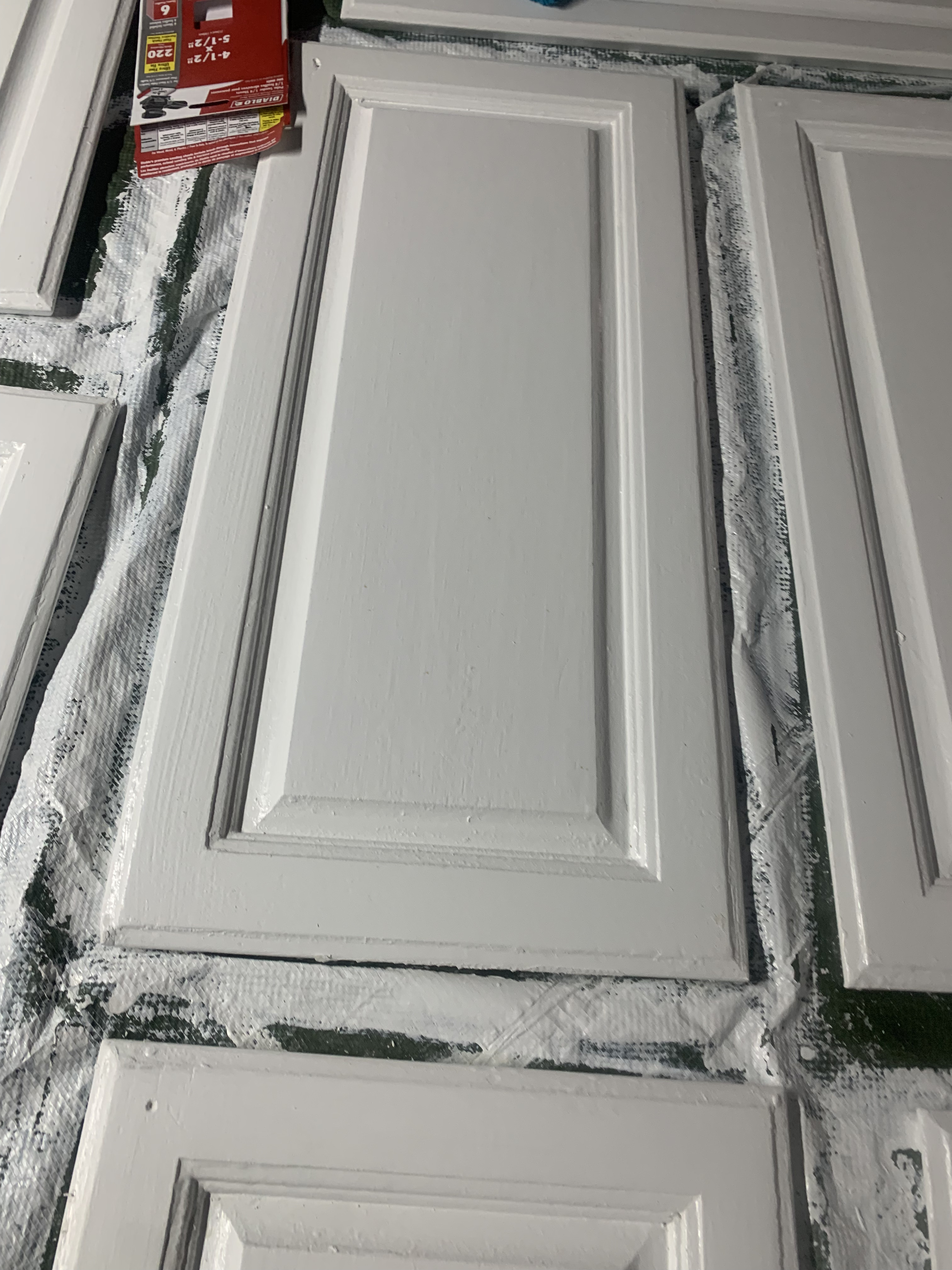 Cabinet doors being painted white