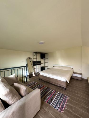 Loft-style bungalow bedroom interior with double bed and sofa