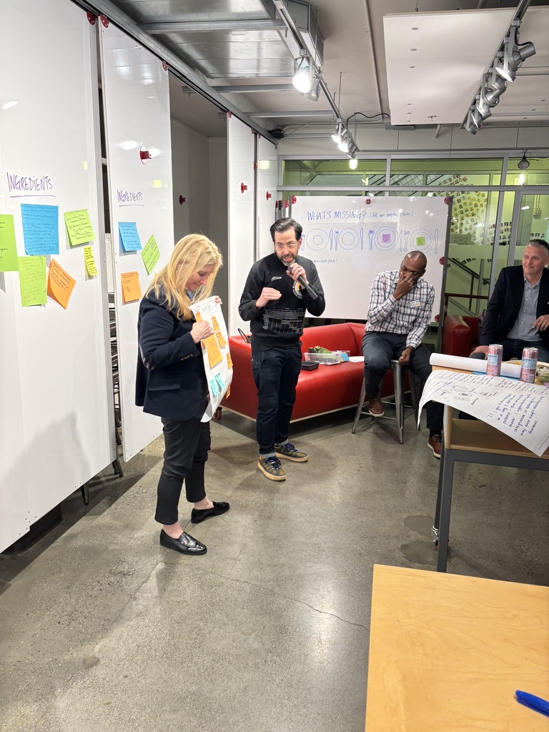 Facilitators presenting with microphone at R&Dinner event