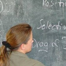 Trainerin schreibt Computer-Begriffe an die Schultafel