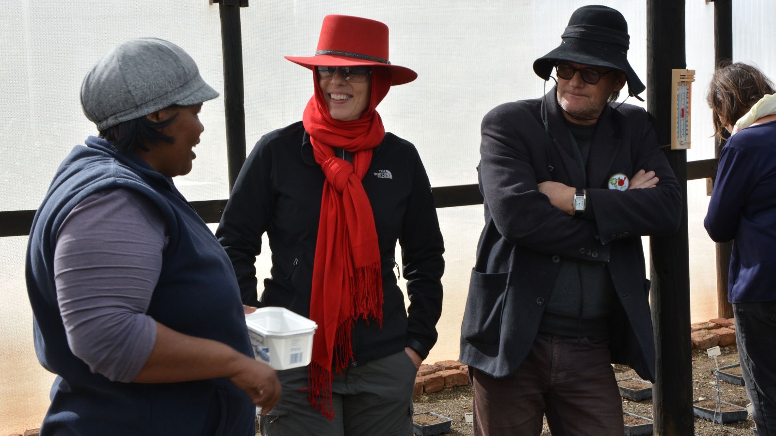 Three people in conversation at community event
