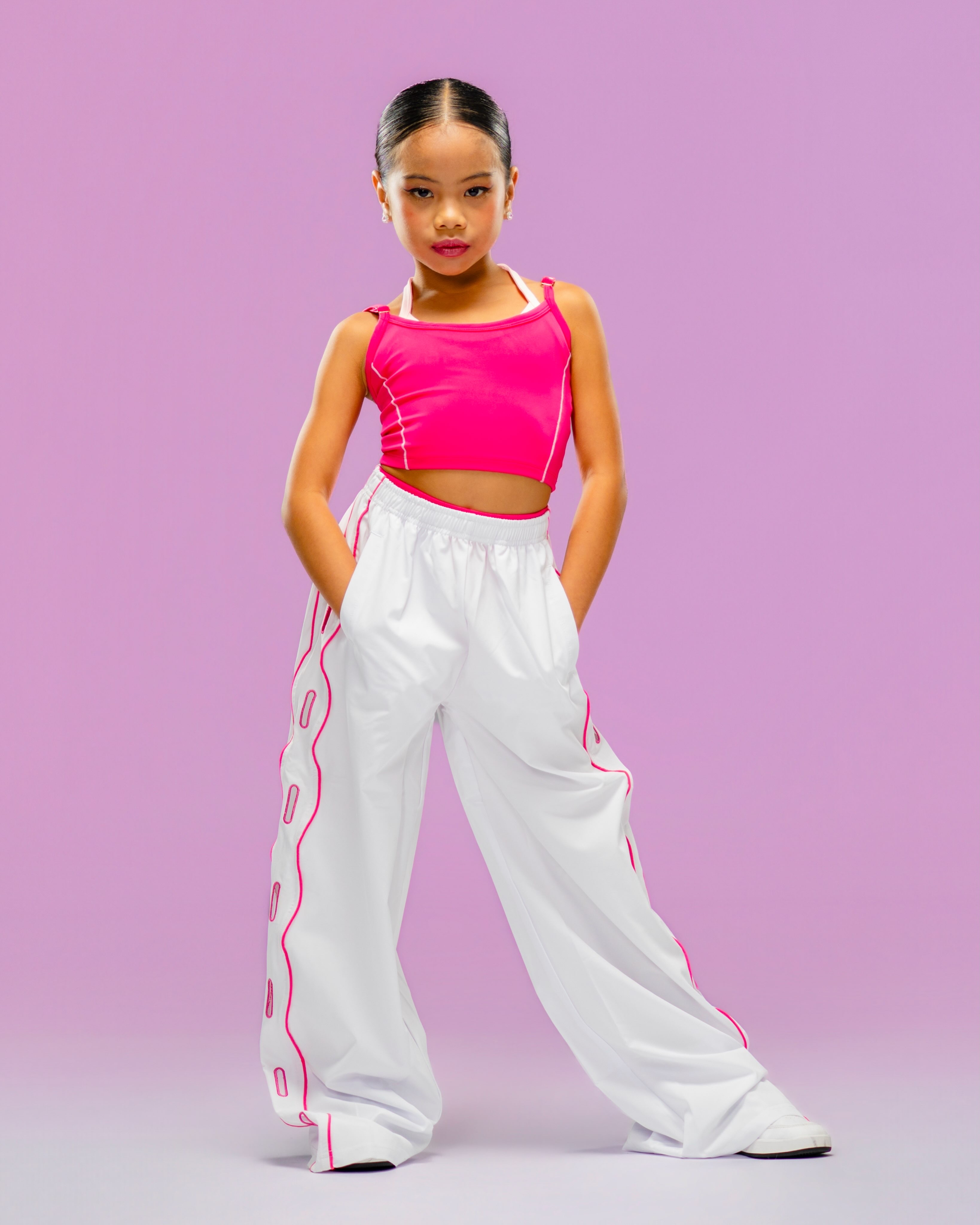 Pichara Luong, child model and young dancer, in a pink and white fashion look