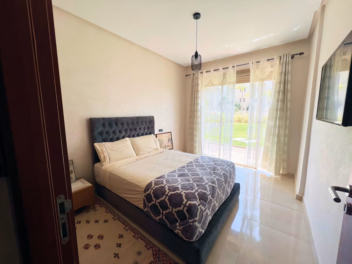 Spacious living room with modern grey sofa and TV