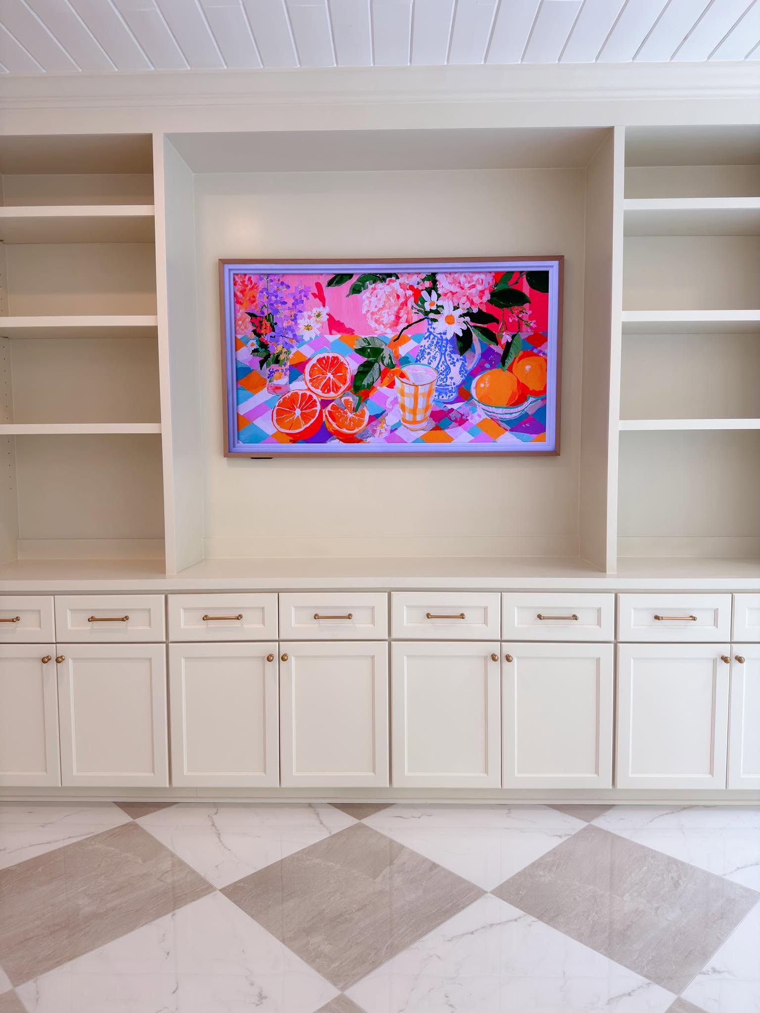 Floor-to-ceiling custom built-ins with brass hardware