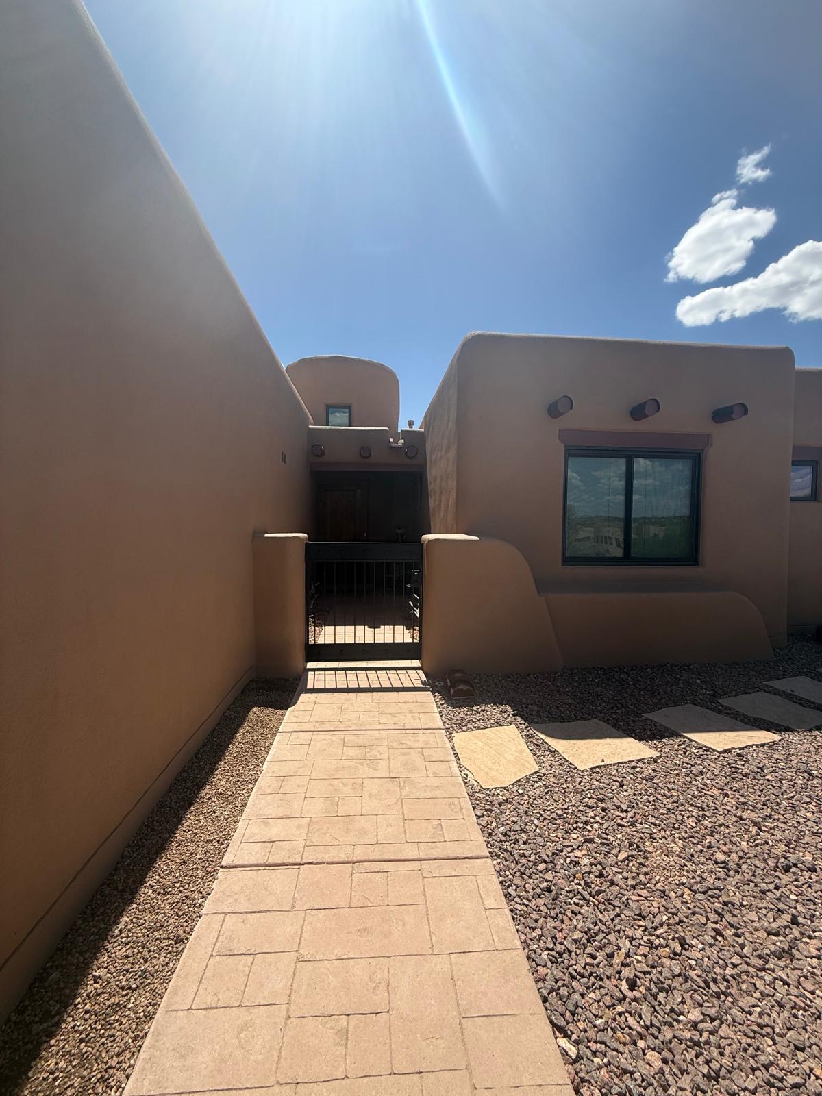 Entry courtyard with stucco walls creating enclosed walkway