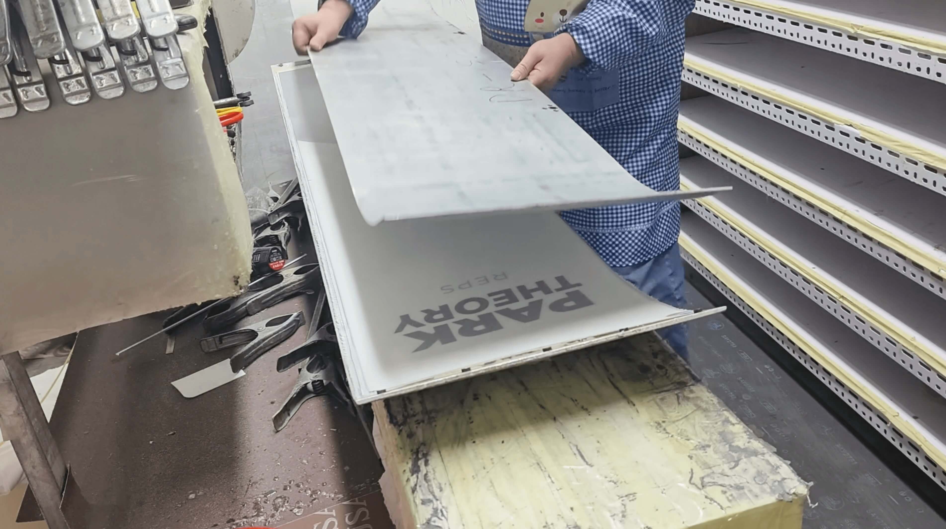 Complete board sandwich stack being placed into the press mold