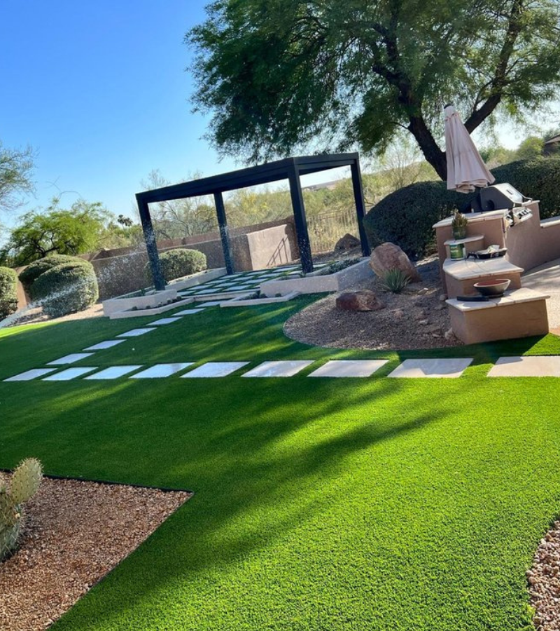 Aerial view of turf and paver checkerboard patio with planter beds
