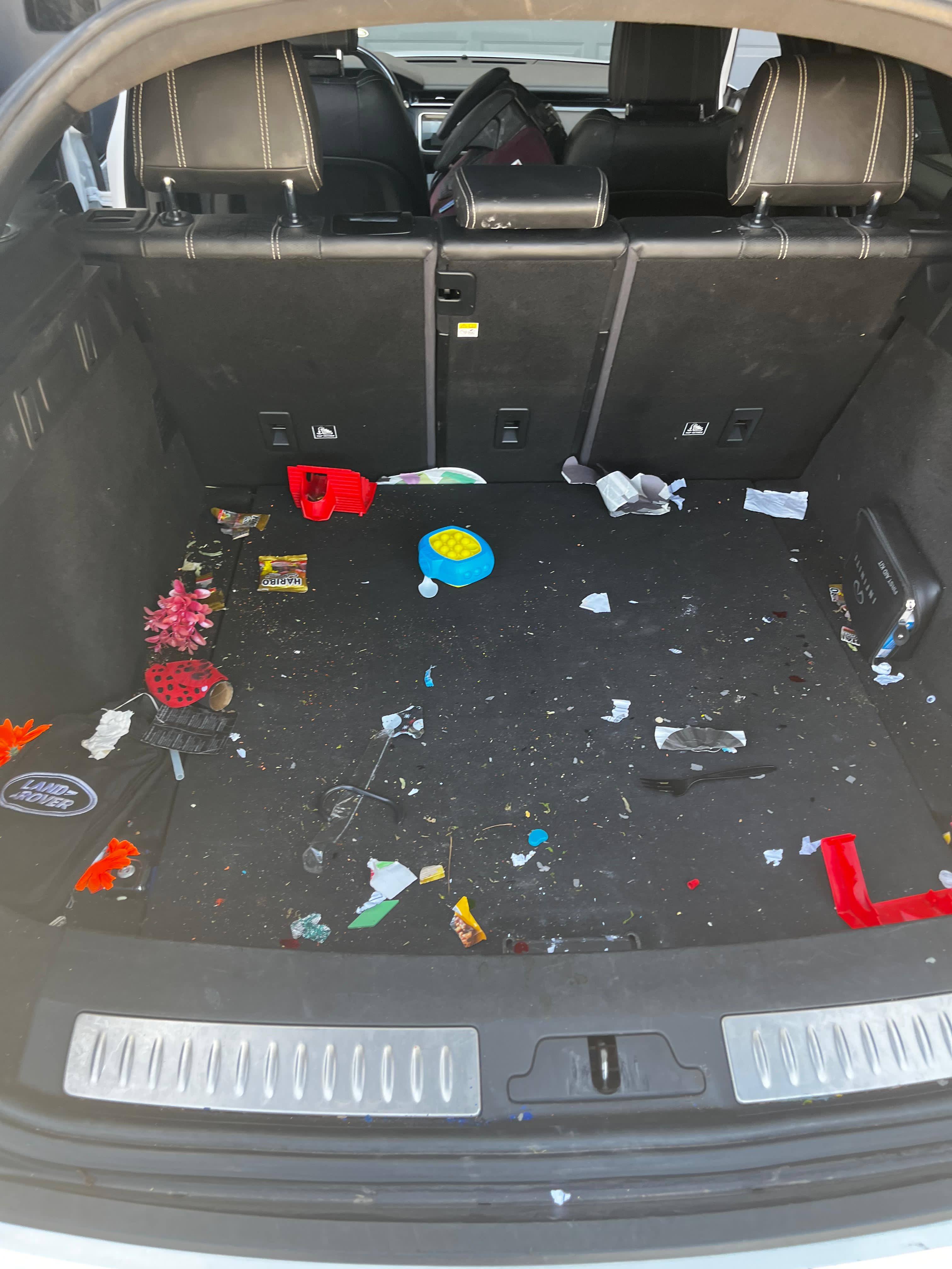 Before: Cluttered cargo area with debris