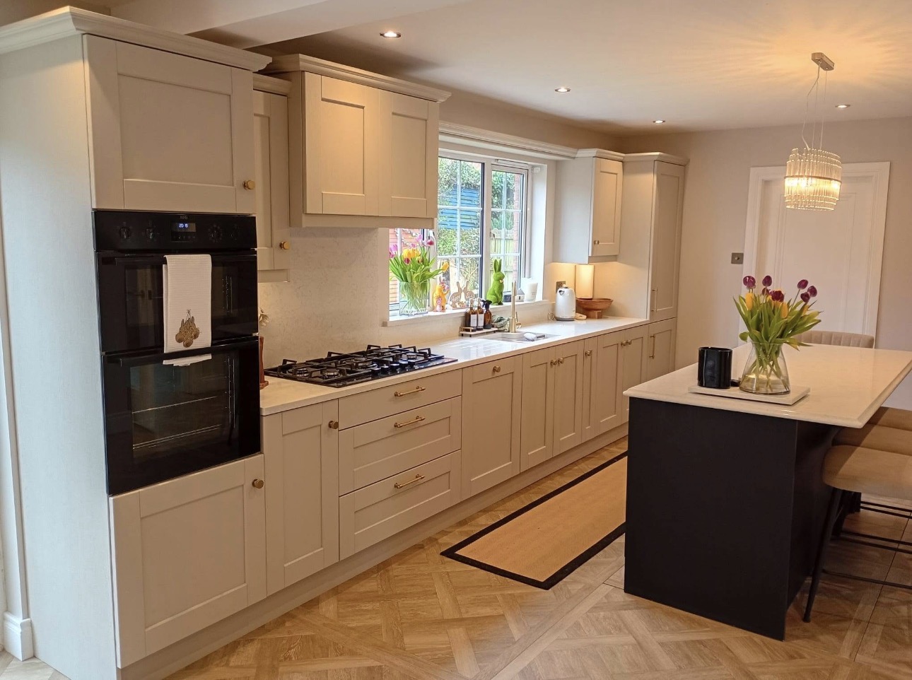 Elegant cream shaker kitchen with integrated appliances and dark island in Belfast