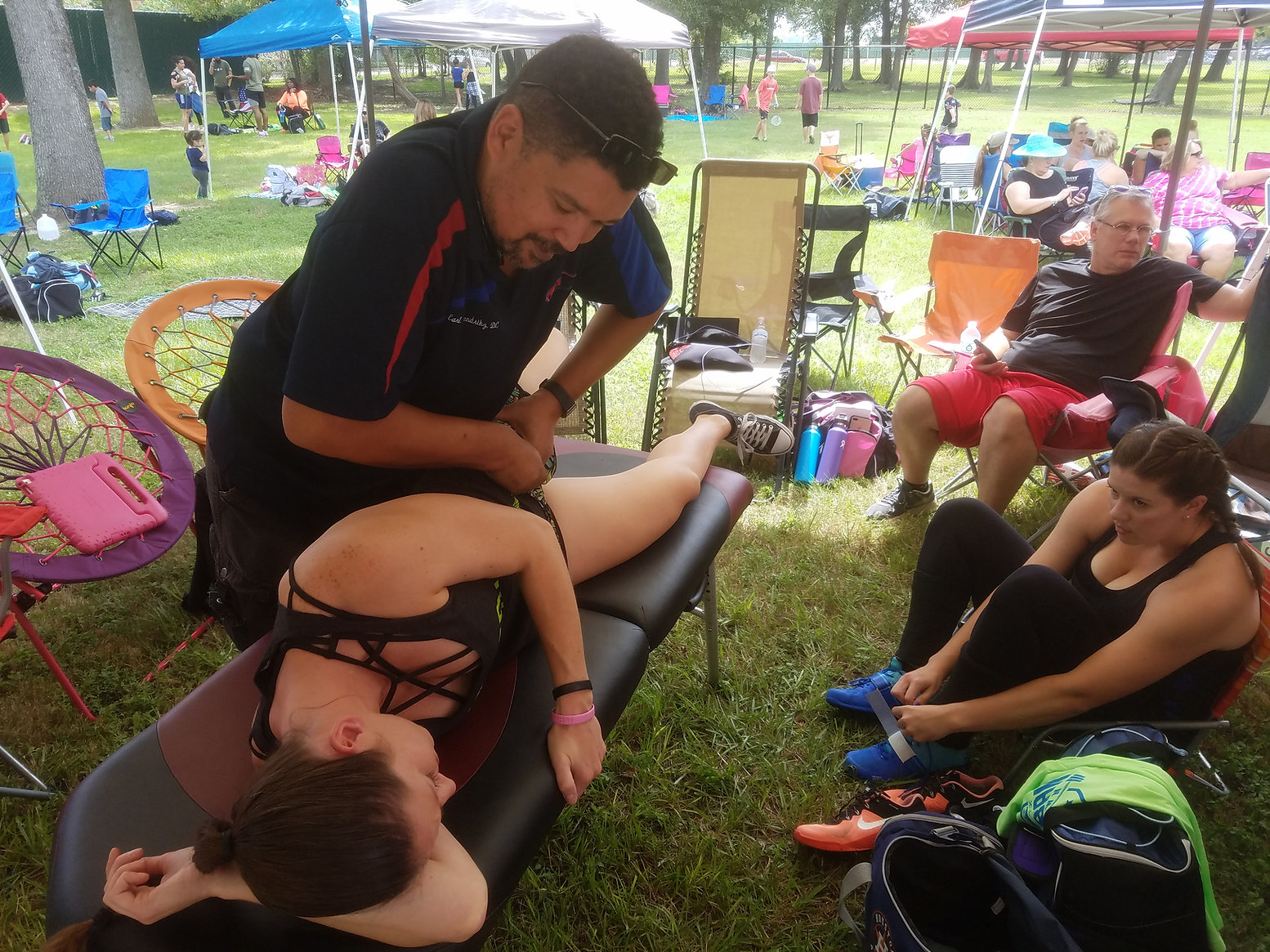 Dr. Earl providing hands-on sports chiropractic care at a community event