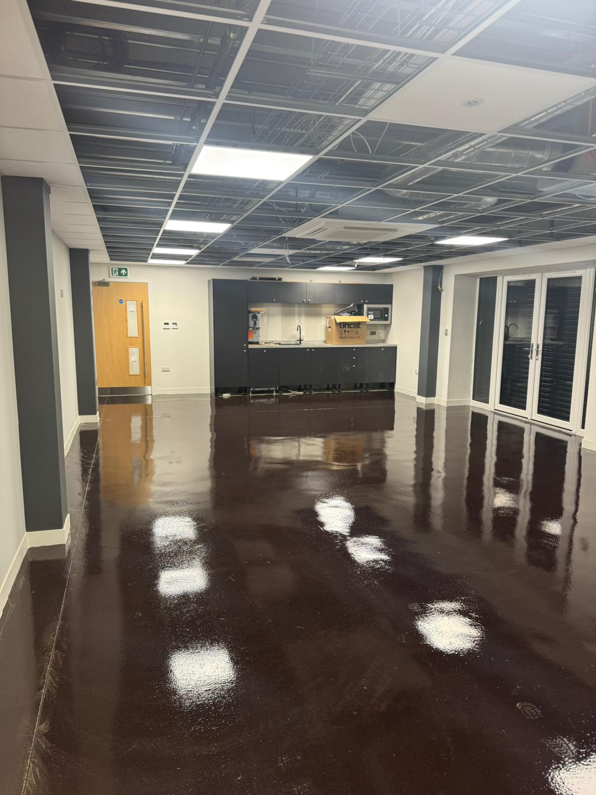 Commercial kitchen with glossy resin flooring